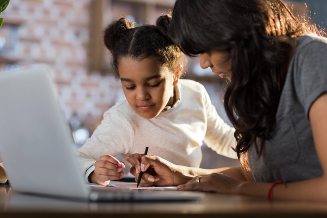 Mother and daughter researching something on a computer